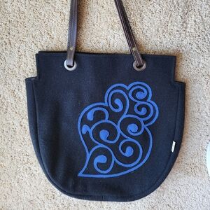 Black wool tote with cobalt blue design and brown leather straps